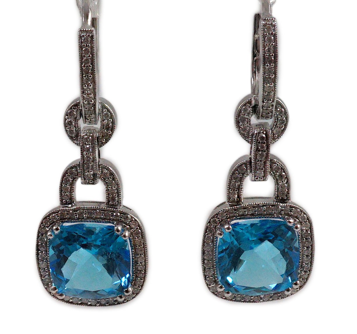 A modern pair of 14kt white gold, blue topaz and diamond chip set drop earrings